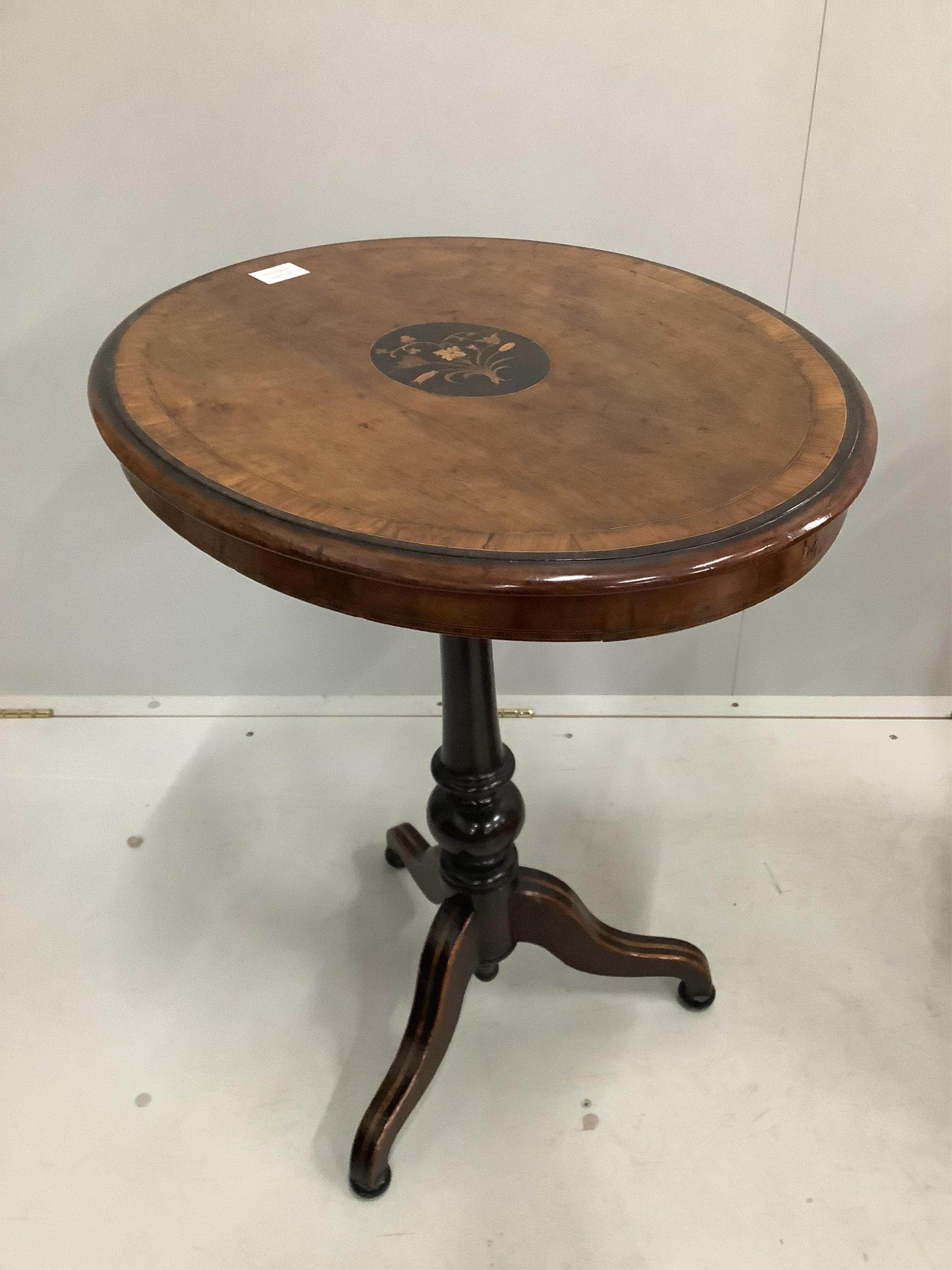 A Victorian inlaid oval walnut tripod table, width 60cm, depth 48cm, height 74cm. Condition - fair